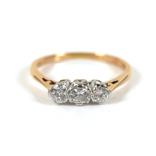 231 - An 18ct yellow gold and platinum three stone diamond ring, head size approximately 11mm by 4mm, size... 