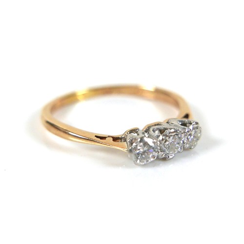 231 - An 18ct yellow gold and platinum three stone diamond ring, head size approximately 11mm by 4mm, size... 