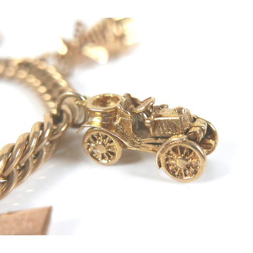 294 - A 9ct yellow gold charm bracelet, fitted with six charms and an Elizabeth ll gold sovereign, 1963, 5... 