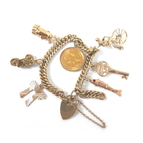 294 - A 9ct yellow gold charm bracelet, fitted with six charms and an Elizabeth ll gold sovereign, 1963, 5... 