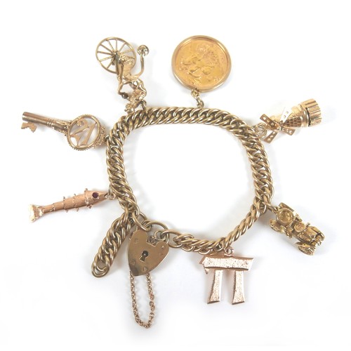 294 - A 9ct yellow gold charm bracelet, fitted with six charms and an Elizabeth ll gold sovereign, 1963, 5... 