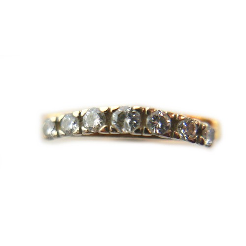 240 - An 18ct yellow gold and diamond ring, set with a gently bowed row of seven round cut stones, 2.5 to ... 