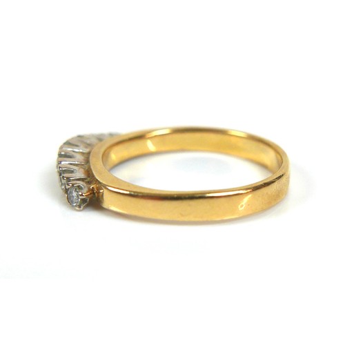 240 - An 18ct yellow gold and diamond ring, set with a gently bowed row of seven round cut stones, 2.5 to ... 