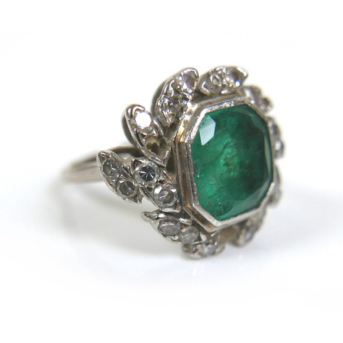 241 - An 18ct white gold dress ring, set with a large octagonal cut emerald, with various fractures and ch... 