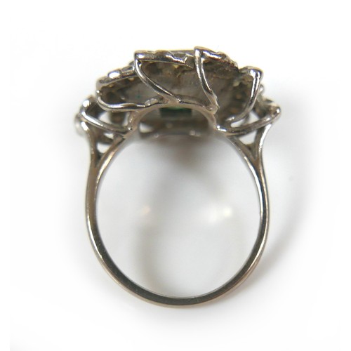 241 - An 18ct white gold dress ring, set with a large octagonal cut emerald, with various fractures and ch... 