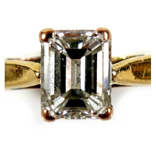 301 - An 18ct yellow gold and diamond solitaire ring, the emerald cut stone, 1.2ct, 5.5 by 4.3 by 2.9mm, i... 