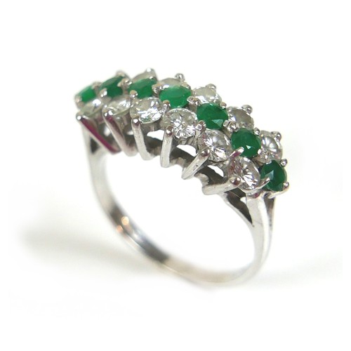 271 - An 18ct white gold diamond and emerald cluster ring, with a single row of eight round cut emeralds, ... 