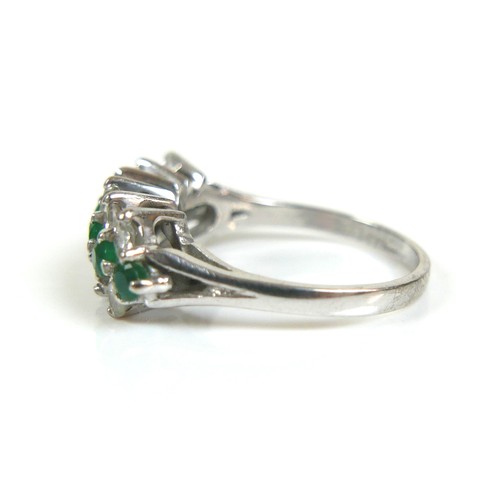 271 - An 18ct white gold diamond and emerald cluster ring, with a single row of eight round cut emeralds, ... 