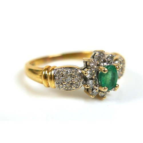 226 - An 18ct gold emerald and diamond daisy cluster ring, the oval cut emerald approximately 3.5mm by 4.5... 