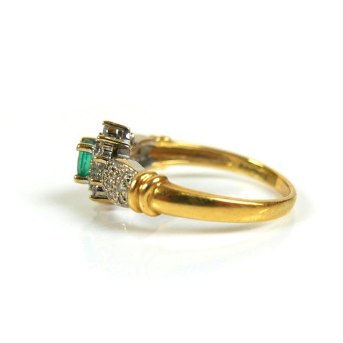 226 - An 18ct gold emerald and diamond daisy cluster ring, the oval cut emerald approximately 3.5mm by 4.5... 