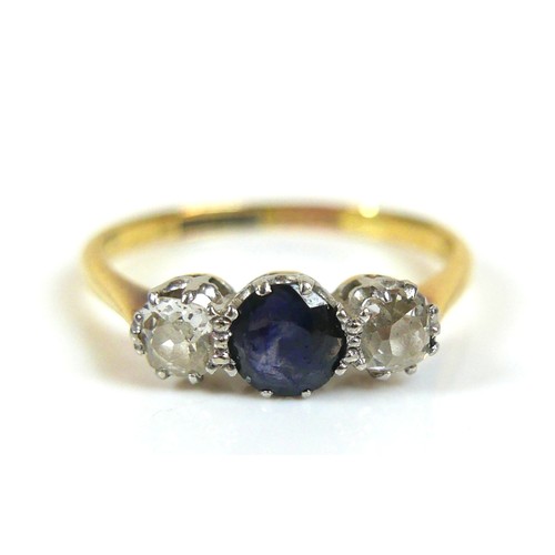 227 - An 18ct gold blue sapphire and diamond ring, the central sapphire approximately 5mm diameter, the ro... 