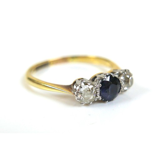 227 - An 18ct gold blue sapphire and diamond ring, the central sapphire approximately 5mm diameter, the ro... 