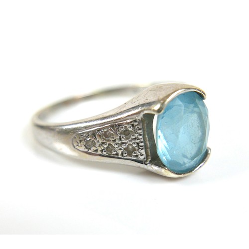 174 - Two 9ct white gold blue stone dress rings, possibly topaz, comprising a square cut stone ring, centr... 