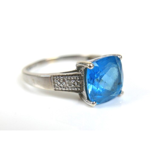 174 - Two 9ct white gold blue stone dress rings, possibly topaz, comprising a square cut stone ring, centr... 