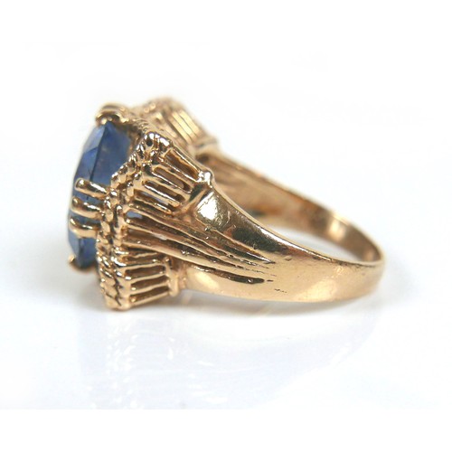 203 - Two gold dress rings, comprising a 9ct yellow gold ring set with a blue round cut stone, 14mm, size ... 