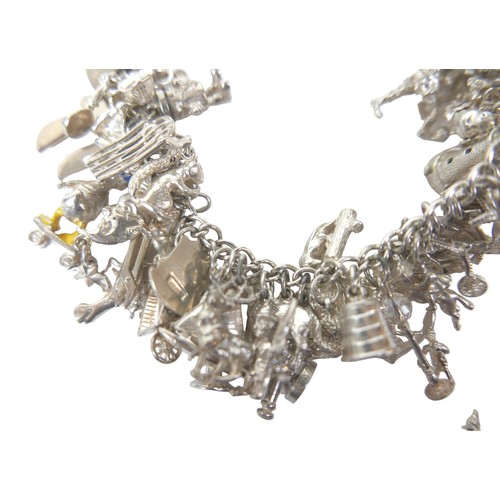 202 - Two silver charm bracelets, fitted with multiple silver and white metal charms, including lighthouse... 