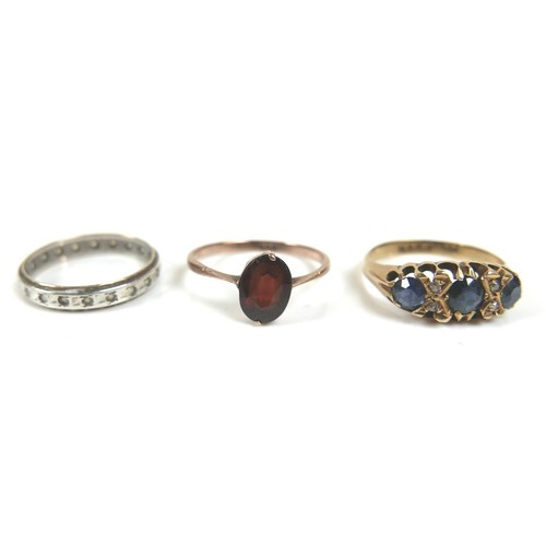 210 - An 18ct gold ring, set with three round cut sapphires, each 5.0mm, and four small diamonds, 1.0mm, s... 