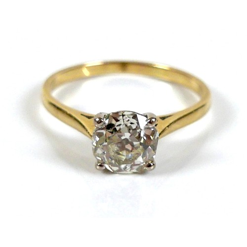 309 - An 18ct yellow gold and diamond solitaire ring, the slightly oval faceted cut stone approximately 1.... 