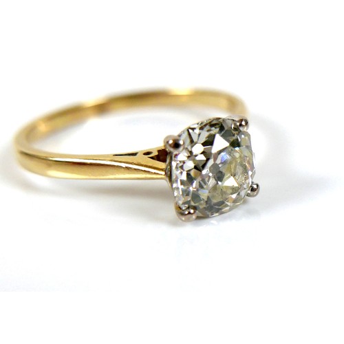 309 - An 18ct yellow gold and diamond solitaire ring, the slightly oval faceted cut stone approximately 1.... 