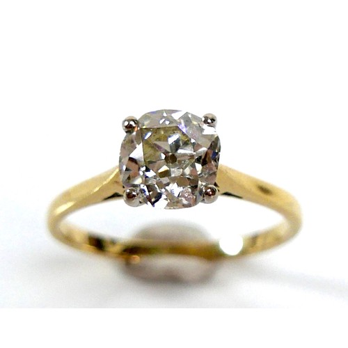 309 - An 18ct yellow gold and diamond solitaire ring, the slightly oval faceted cut stone approximately 1.... 