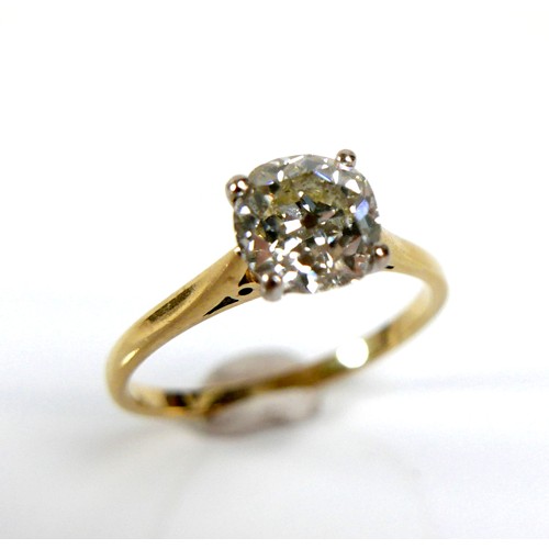 309 - An 18ct yellow gold and diamond solitaire ring, the slightly oval faceted cut stone approximately 1.... 