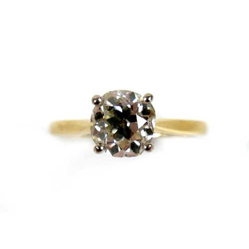 309 - An 18ct yellow gold and diamond solitaire ring, the slightly oval faceted cut stone approximately 1.... 