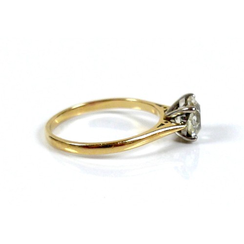 309 - An 18ct yellow gold and diamond solitaire ring, the slightly oval faceted cut stone approximately 1.... 