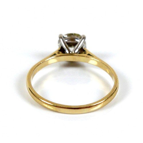 309 - An 18ct yellow gold and diamond solitaire ring, the slightly oval faceted cut stone approximately 1.... 