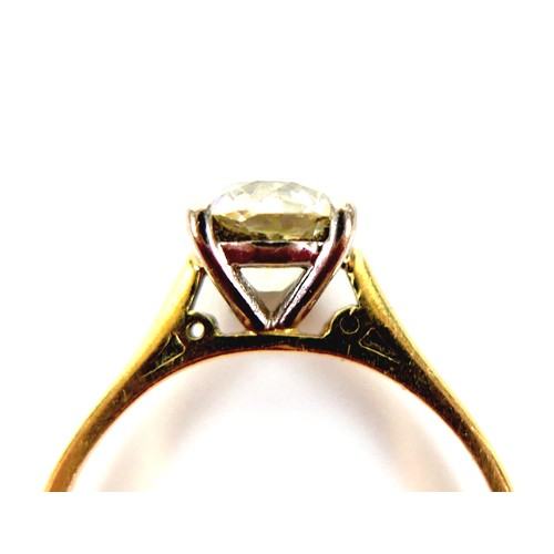 309 - An 18ct yellow gold and diamond solitaire ring, the slightly oval faceted cut stone approximately 1.... 