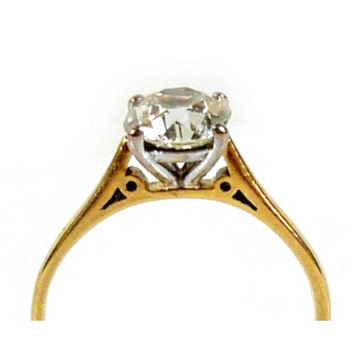 309 - An 18ct yellow gold and diamond solitaire ring, the slightly oval faceted cut stone approximately 1.... 