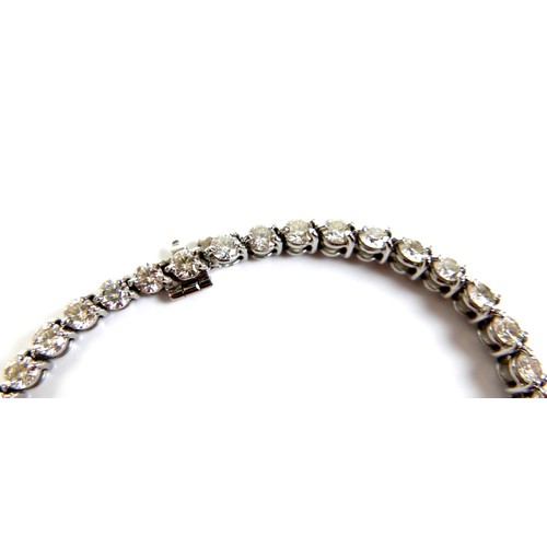 311 - An 18ct white gold and diamond tennis bracelet, set with forty round brilliant cut stones, each appr... 