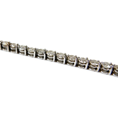 311 - An 18ct white gold and diamond tennis bracelet, set with forty round brilliant cut stones, each appr... 