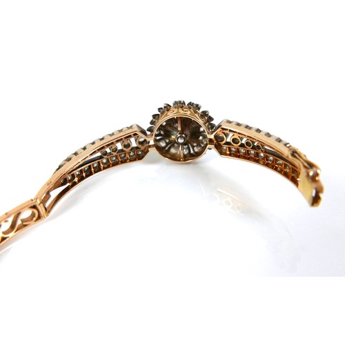 302 - A French early 20th century 18ct yellow gold and white metal diamond hinged bangle, the central flow... 