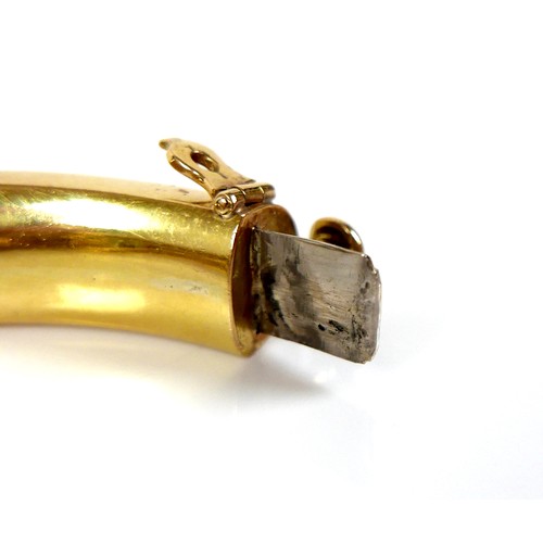 308 - An 18ct yellow gold hinged bangle, formed as a lion grasping it's tail in it's jaws, with inset cabo... 