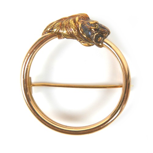 268 - An 18ct yellow gold brooch, formed as an open circle with lion's head terminal, with pierced holes f... 