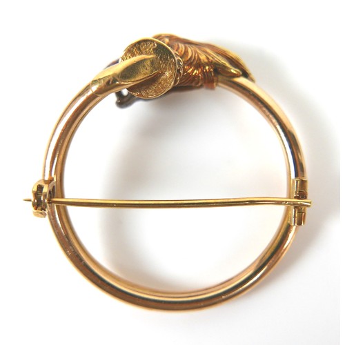 268 - An 18ct yellow gold brooch, formed as an open circle with lion's head terminal, with pierced holes f... 