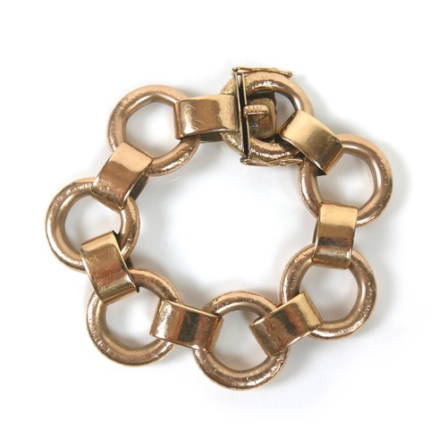 291 - A 9ct yellow gold bracelet, formed of seven oversized rings joined by flattened loops, press clasp w... 