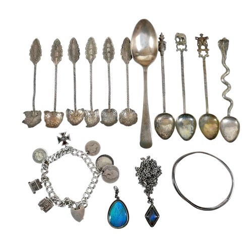 151A - A group of silver jewellery, comprising a charm bracelet, with 19th century coins, miniature bible, ... 