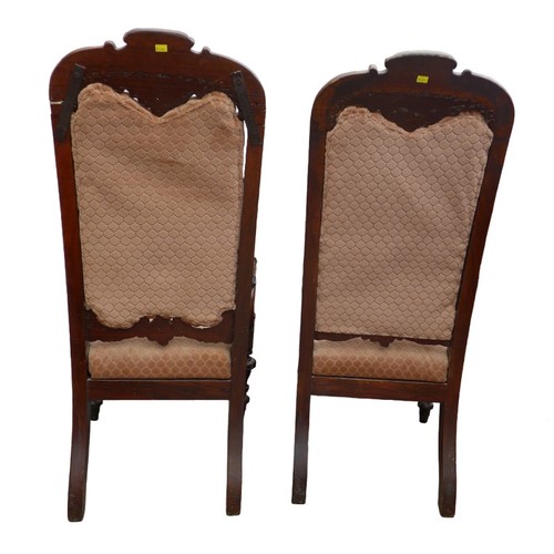 500 - A pair of mid Victorian mahogany open arm chairs, with carved top rail, padded back and seat, uphols... 