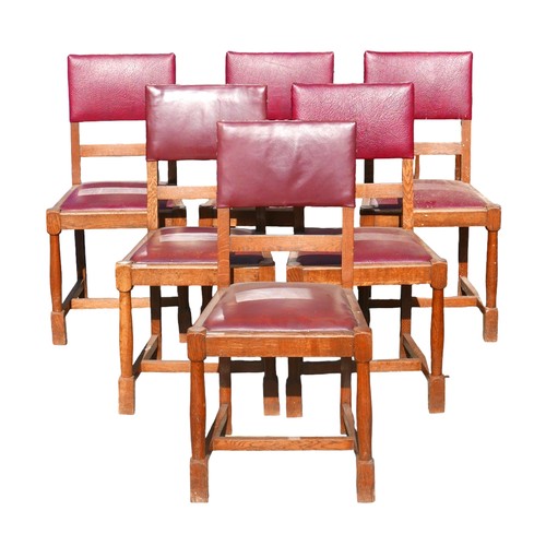 523 - A set of six oak dining chairs, mid 20th century, with burgundy leatherette seats and backs, turned ... 