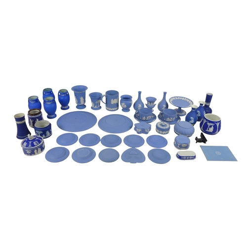 52 - A large group of Wedgwood blue jasperware, including vases, plates, two cups and saucers, comport, a... 