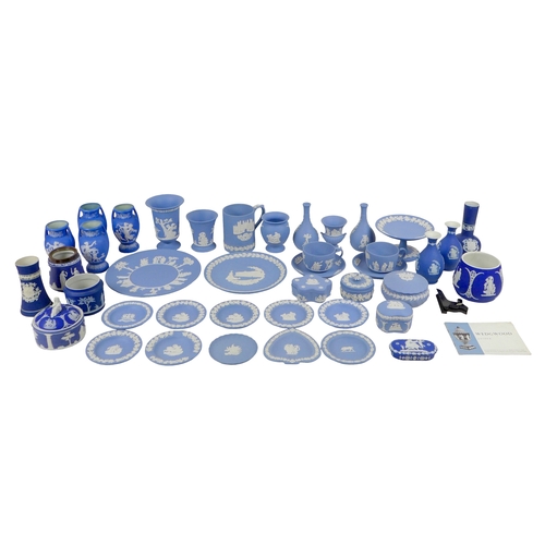 52 - A large group of Wedgwood blue jasperware, including vases, plates, two cups and saucers, comport, a... 