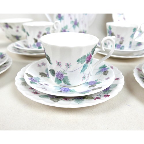 81 - A modern hand painted bone china tea set, decorated with purple flowers and leaves, each signed 'Han... 