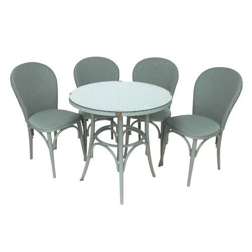 554 - A modern Lloyd Loom Bistro set, green painted wicker, comprising a table with circular glass top, 76... 