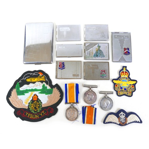 282 - Three WWl medals, three cloth badges and eight stamp/cigarette cases, the medals to 266298 SPR WH OT... 