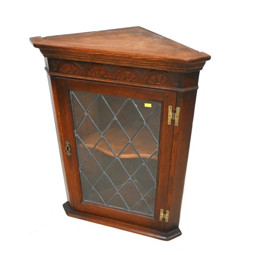 497 - An oak leaded glazed corner cupboard, 53 by 72cm.