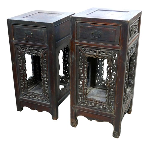 553 - A pair of Chinese carved vase stands with a single drawer and carved panels, 40 by 43 by 88cm high, ... 