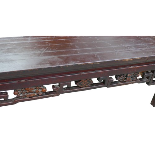 533 - A Chinese hardwood low opium side table with carved frieze, 113 by 34 by 40cm.