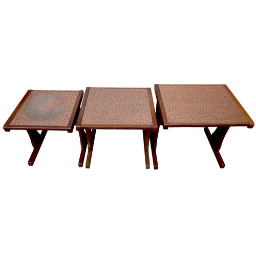 476 - A nest of three G-Plan side tables with textured copper tops, largest 52 by 4.5 by 48cm high. (3)