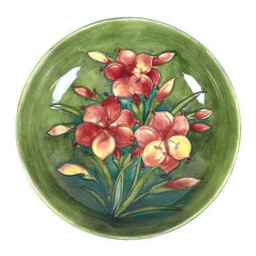 62 - A William Moorcroft fruit bowl, mid 20th century, decorated in the 'Freesia' pattern, 31cm by 9.5cm ... 